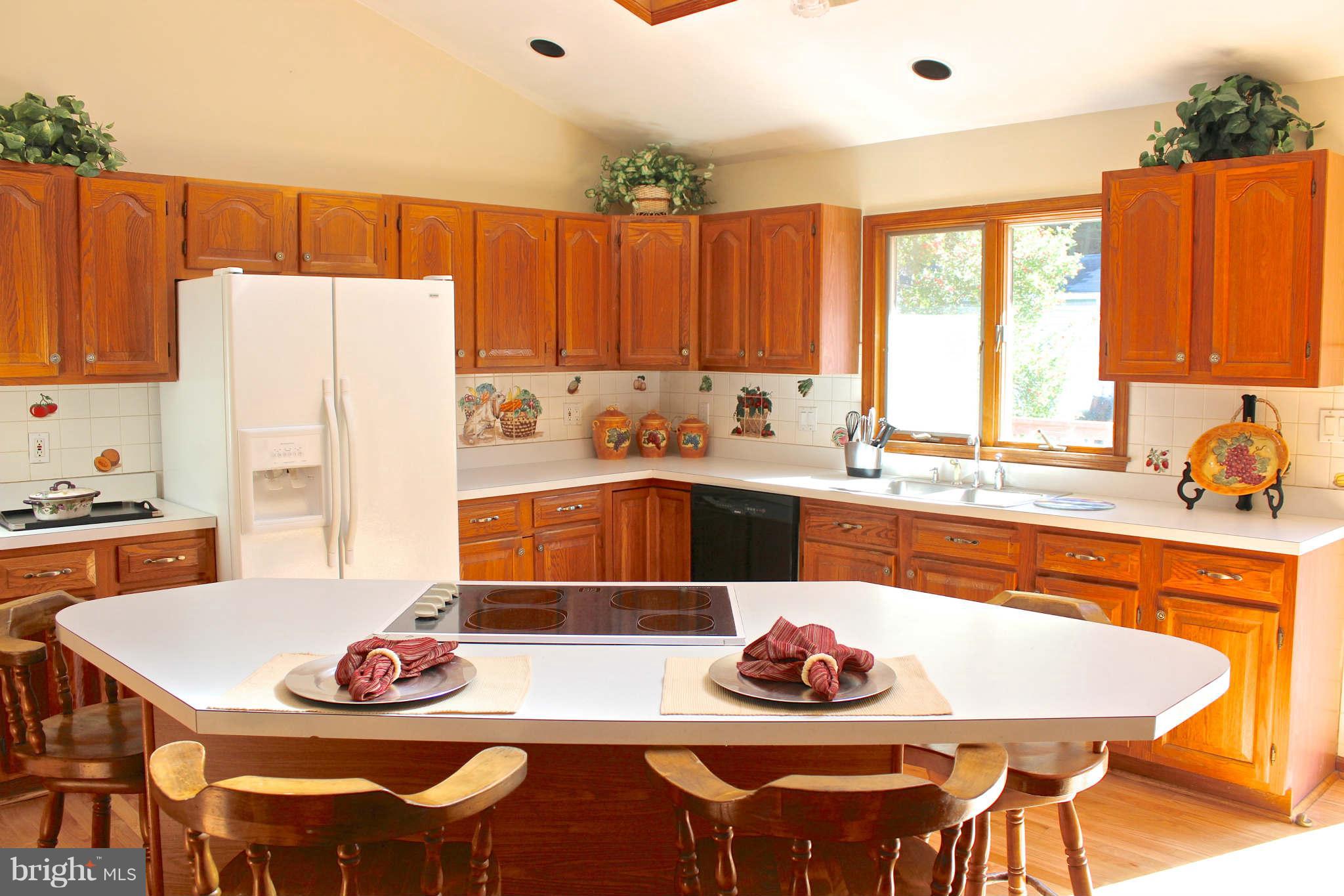 3697 Altondale Road Reisterstown, MD 21136 - Photo 6 of 21 a kitchen with a table chairs stove and refrigerator