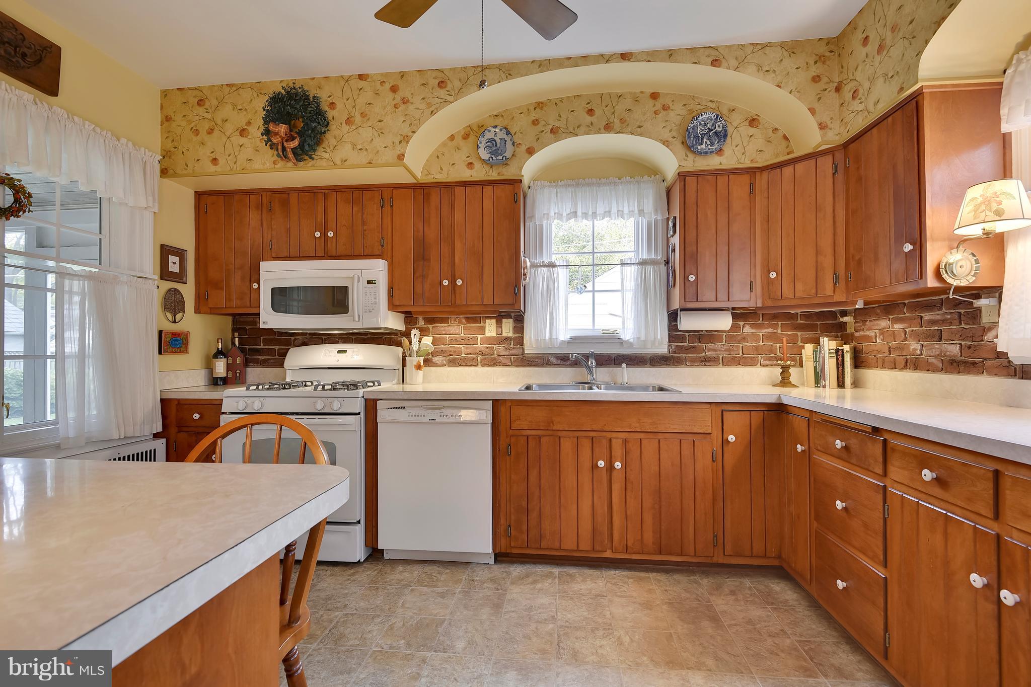 708 Stoneleigh Road Baltimore, MD 21212 - Photo 19 of 61 a kitchen with a sink stove and microwave