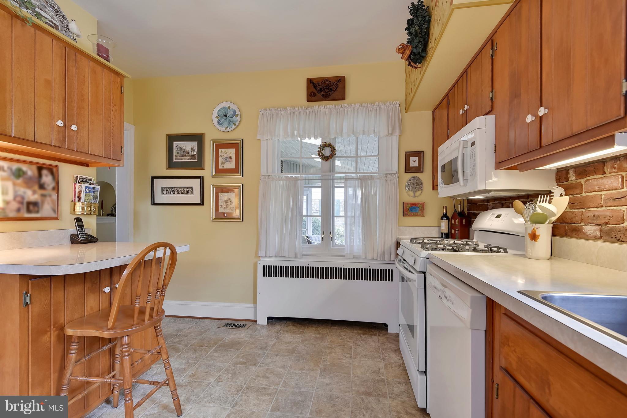 708 Stoneleigh Road Baltimore, MD 21212 - Photo 21 of 61 a kitchen with stainless steel appliances granite countertop a sink a stove and a refrigerator