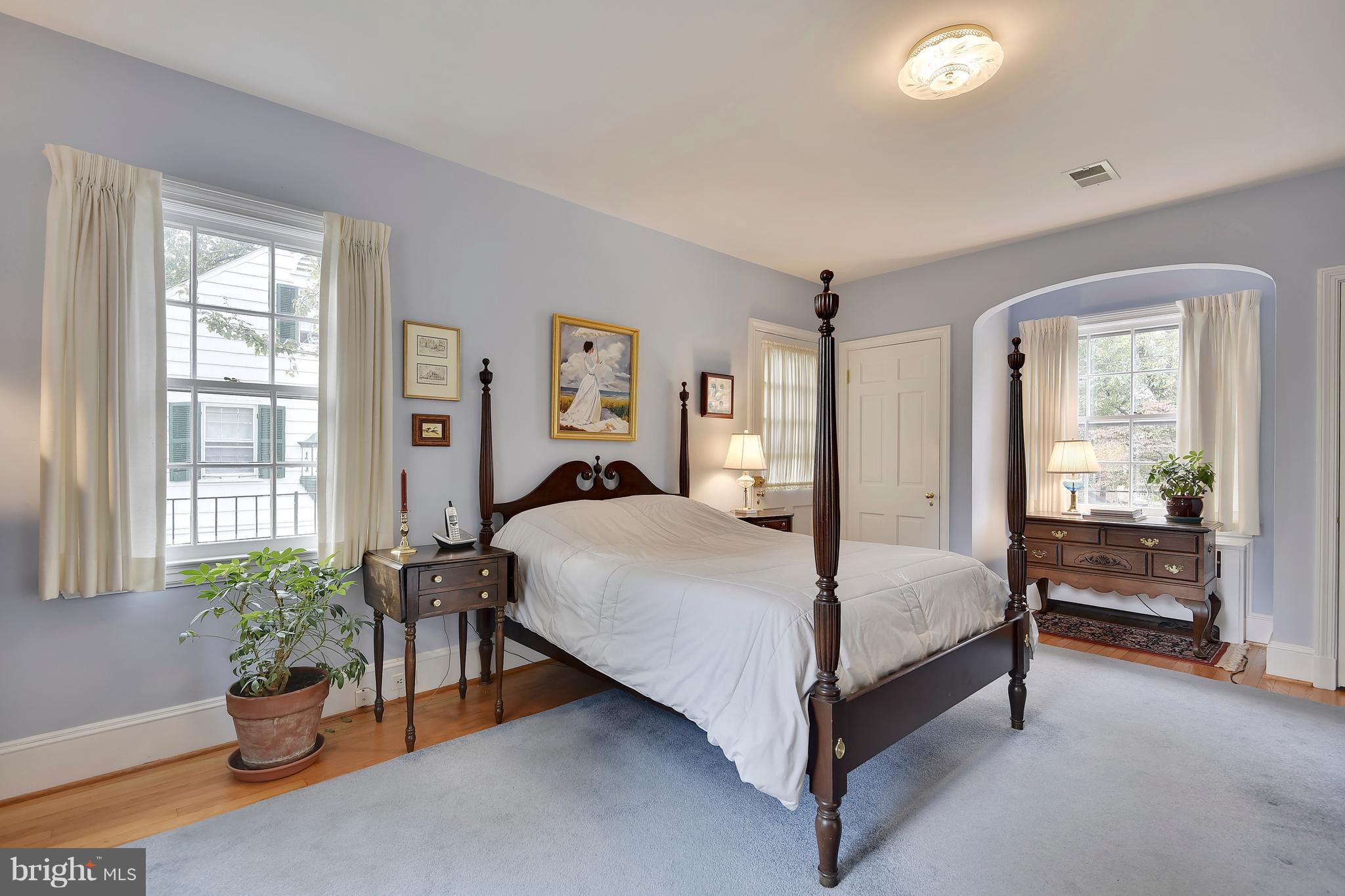 708 Stoneleigh Road Baltimore, MD 21212 - Photo 38 of 61 a bedroom with a bed and potted plant next to a window