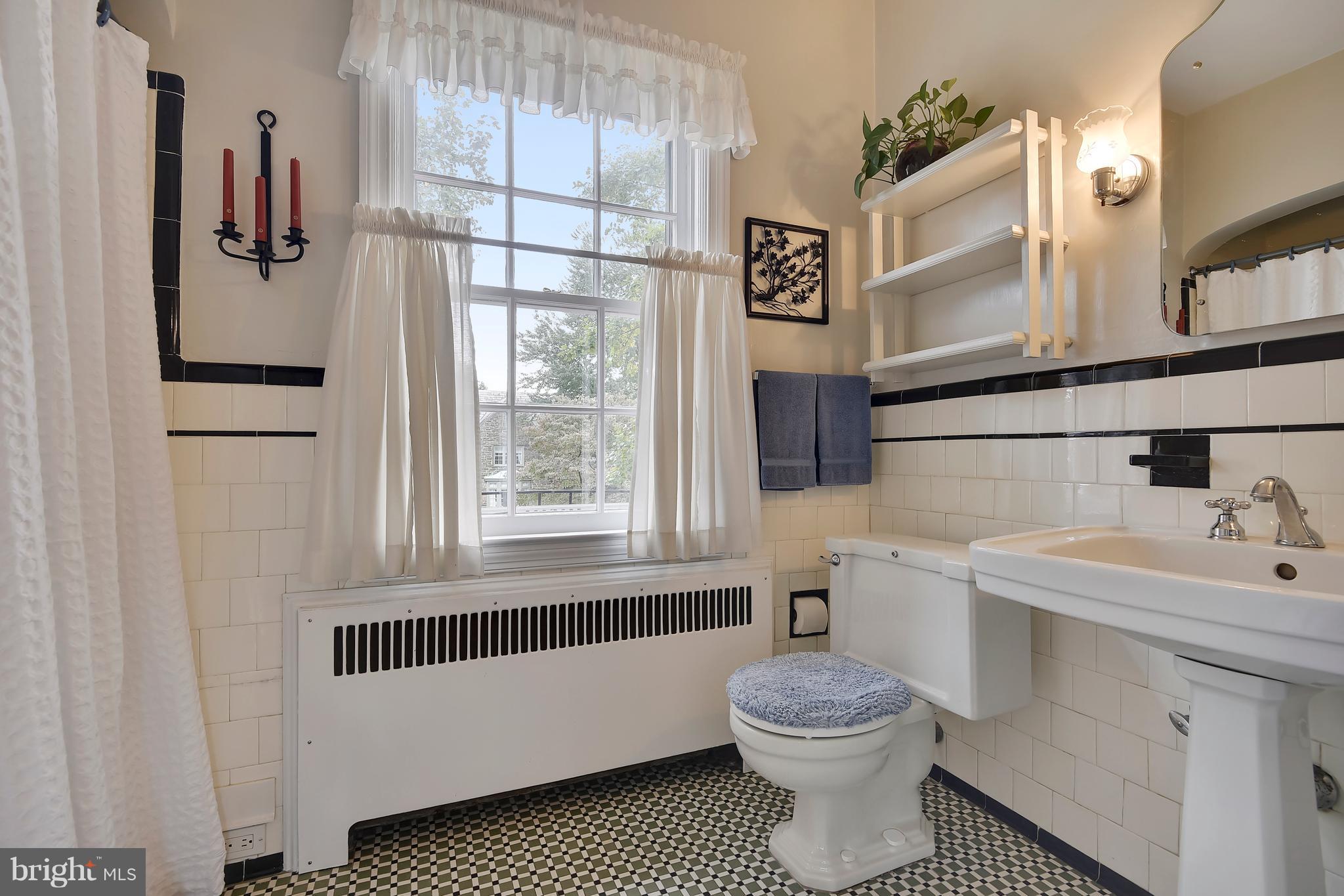 708 Stoneleigh Road Baltimore, MD 21212 - Photo 46 of 61 a bathroom with a sink toilet and window