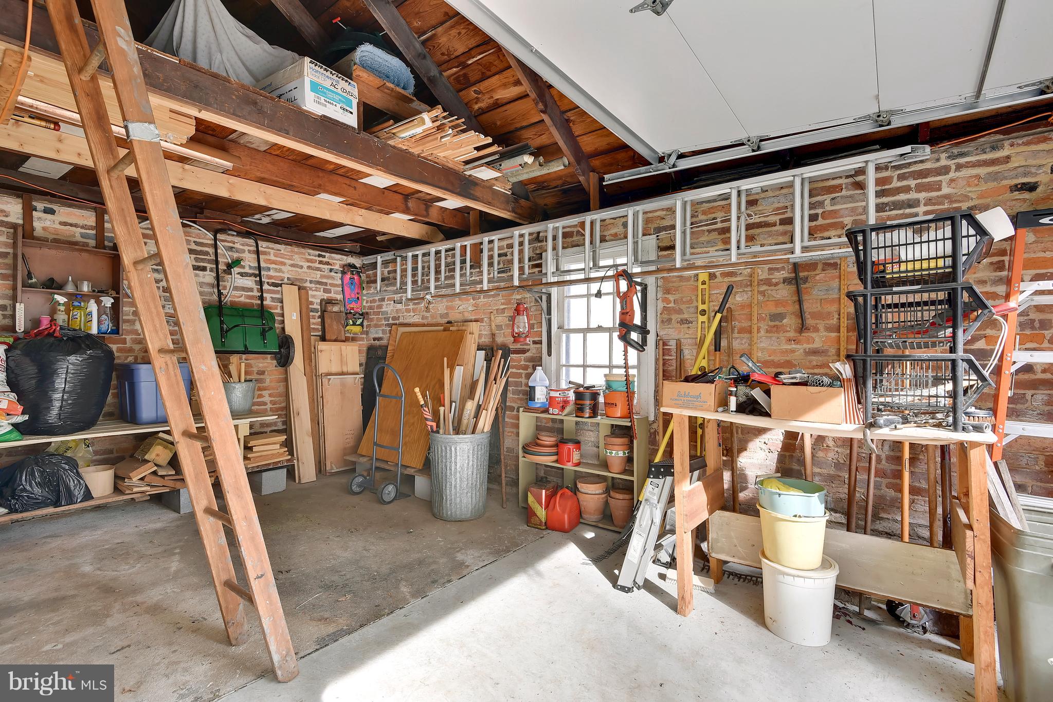 708 Stoneleigh Road Baltimore, MD 21212 - Photo 50 of 61 a view of a storage room with water heater and racks