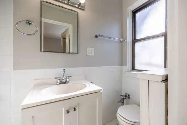 a room with gym equipment and large mirror