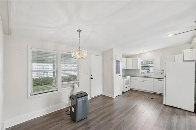 a kitchen with a wooden floor and a window