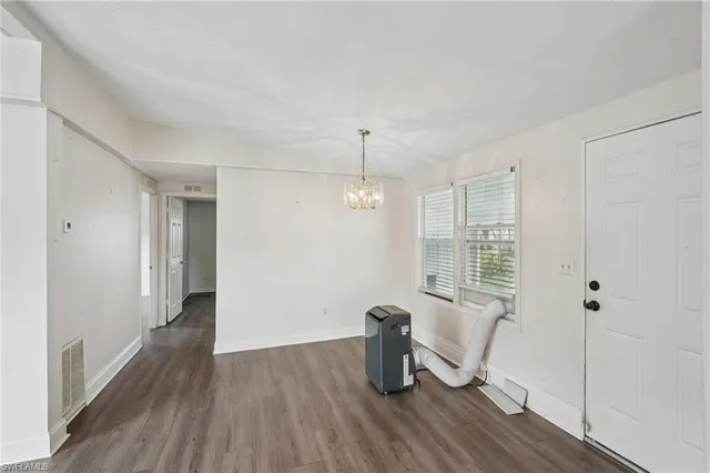 a view of a room with wooden floor and windows