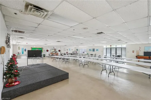 a living room with lots of furniture and a kitchen view