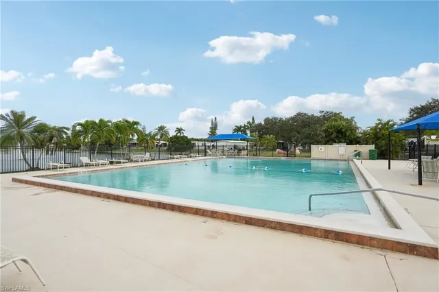 a view of a patio with a table chairs and a backyard
