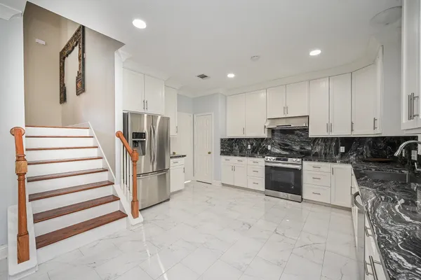 a view of a dining room with furniture and a chandelier