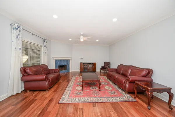 a view of empty room with wooden floor and window