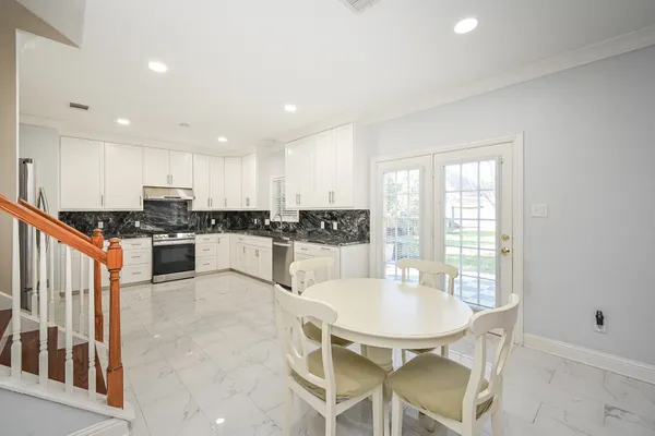a dining room with wooden floor a glass table and chairs