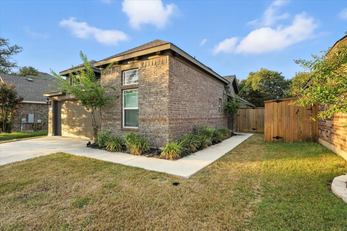 305 Old Trinity Way Georgetown, TX 78628 - Photo 3 of 23 a front view of a house with garden