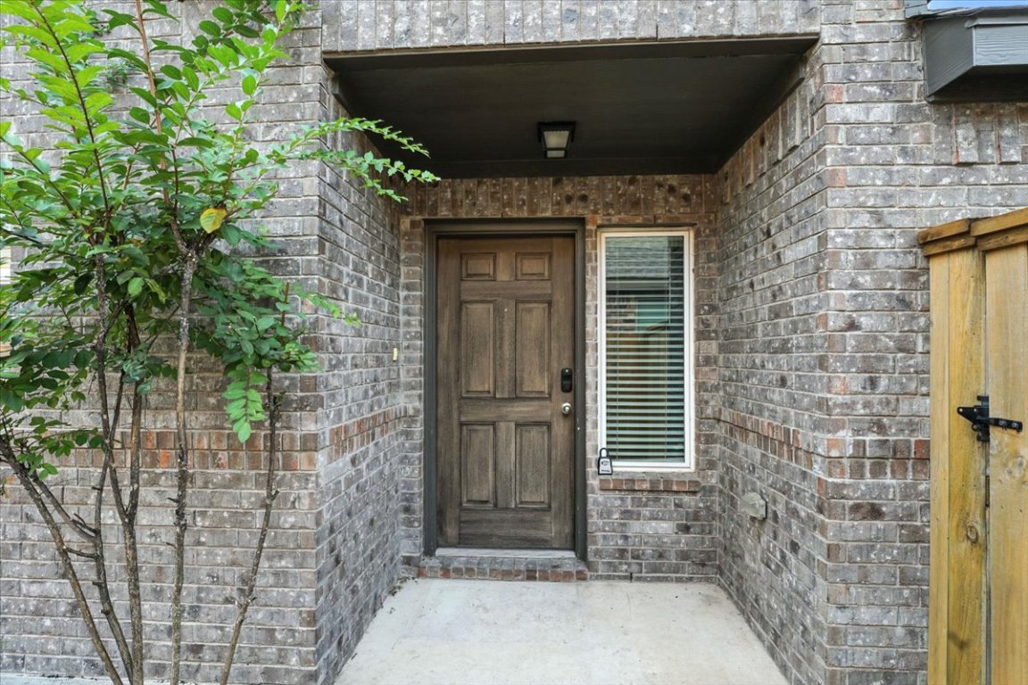 305 Old Trinity Way Georgetown, TX 78628 - Photo 4 of 23 a brick house with a tree in front of it