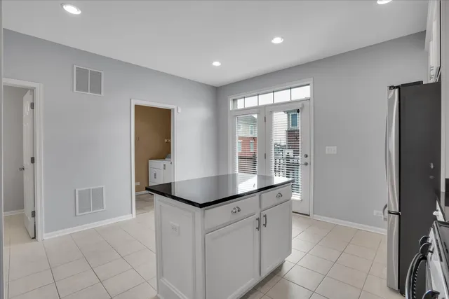 a kitchen with stainless steel appliances granite countertop a refrigerator and a sink