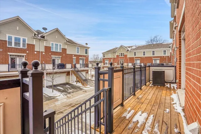 a view of a house with wooden deck