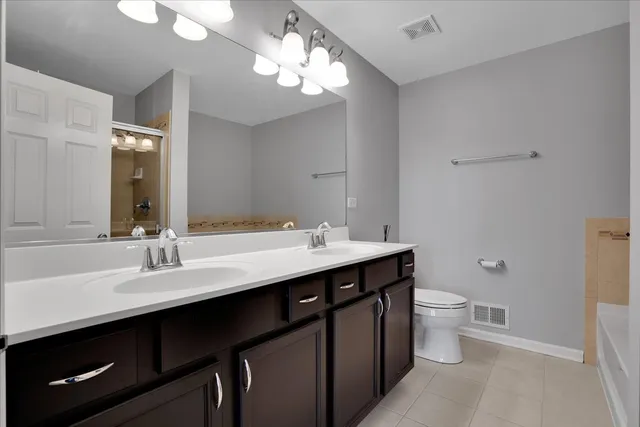 a bathroom with a double vanity sink and a mirror