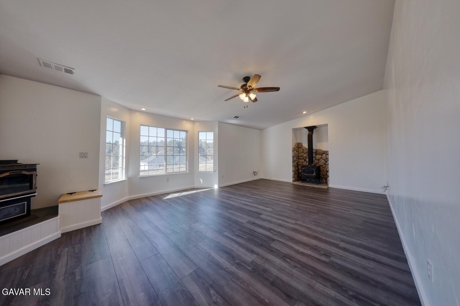 26801 Cabriolet Court Tehachapi, CA 93561 - Photo 7 of 60 a view of an empty room with a window and wooden floor