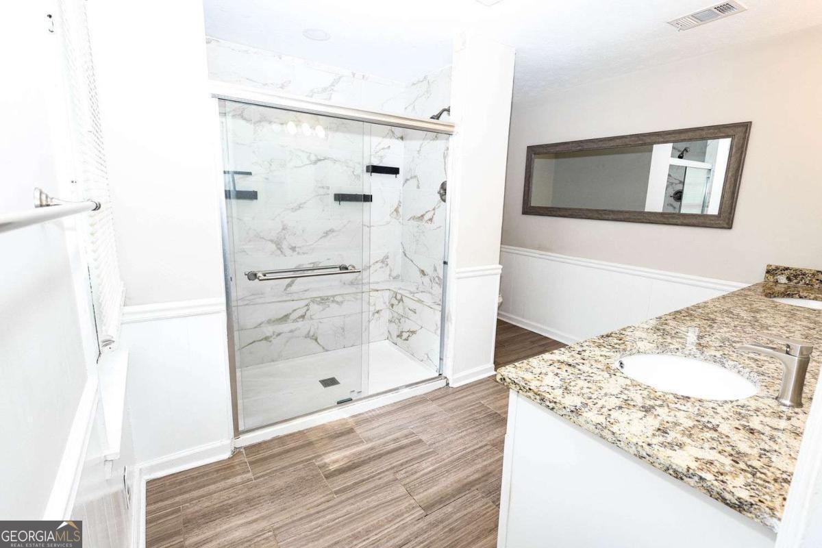 218 East Bonacre Road Cataula, GA 31804 - Photo 15 of 24 a bathroom with a granite countertop mirror and a shower