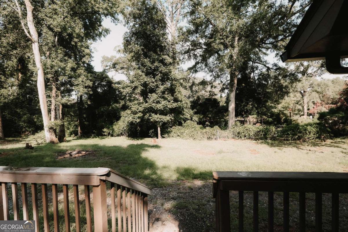 218 East Bonacre Road Cataula, GA 31804 - Photo 24 of 24 a view of a yard with wooden fence and trees