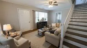 a living room with furniture and a chandelier