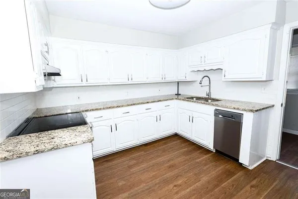 a kitchen with a white cabinets and white appliances