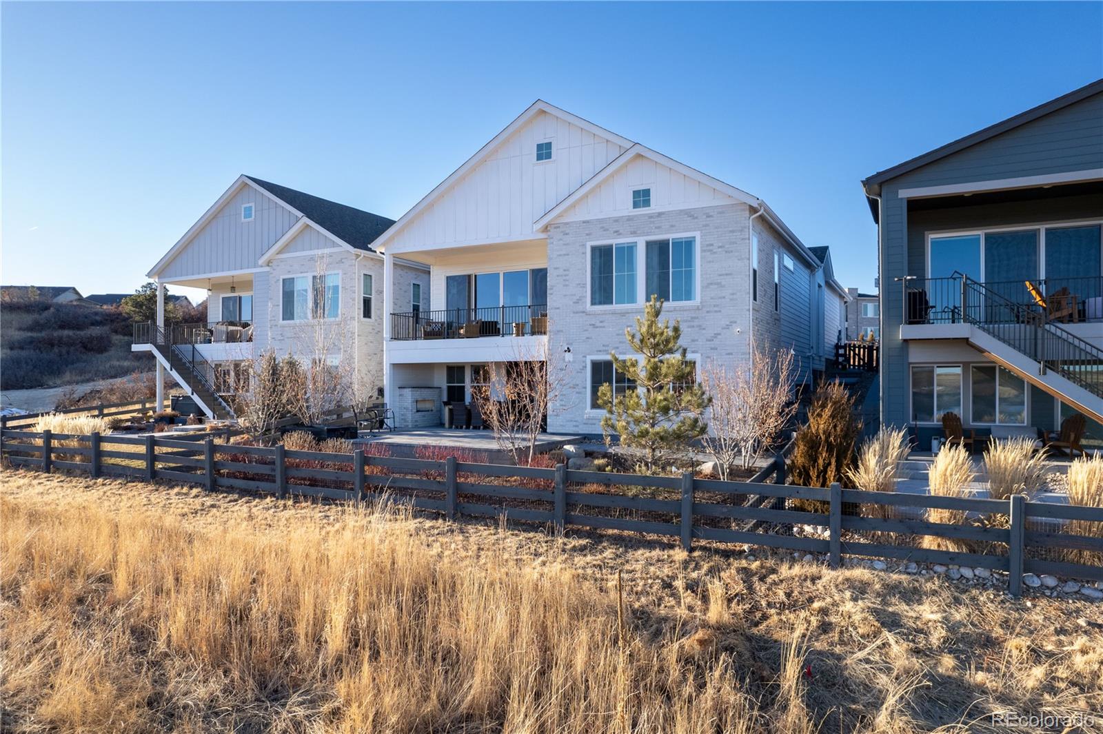 6976 Rim Ridge Drive Castle Pines, CO 80108 - Photo 45 of 50 a front view of a house with swimming pool