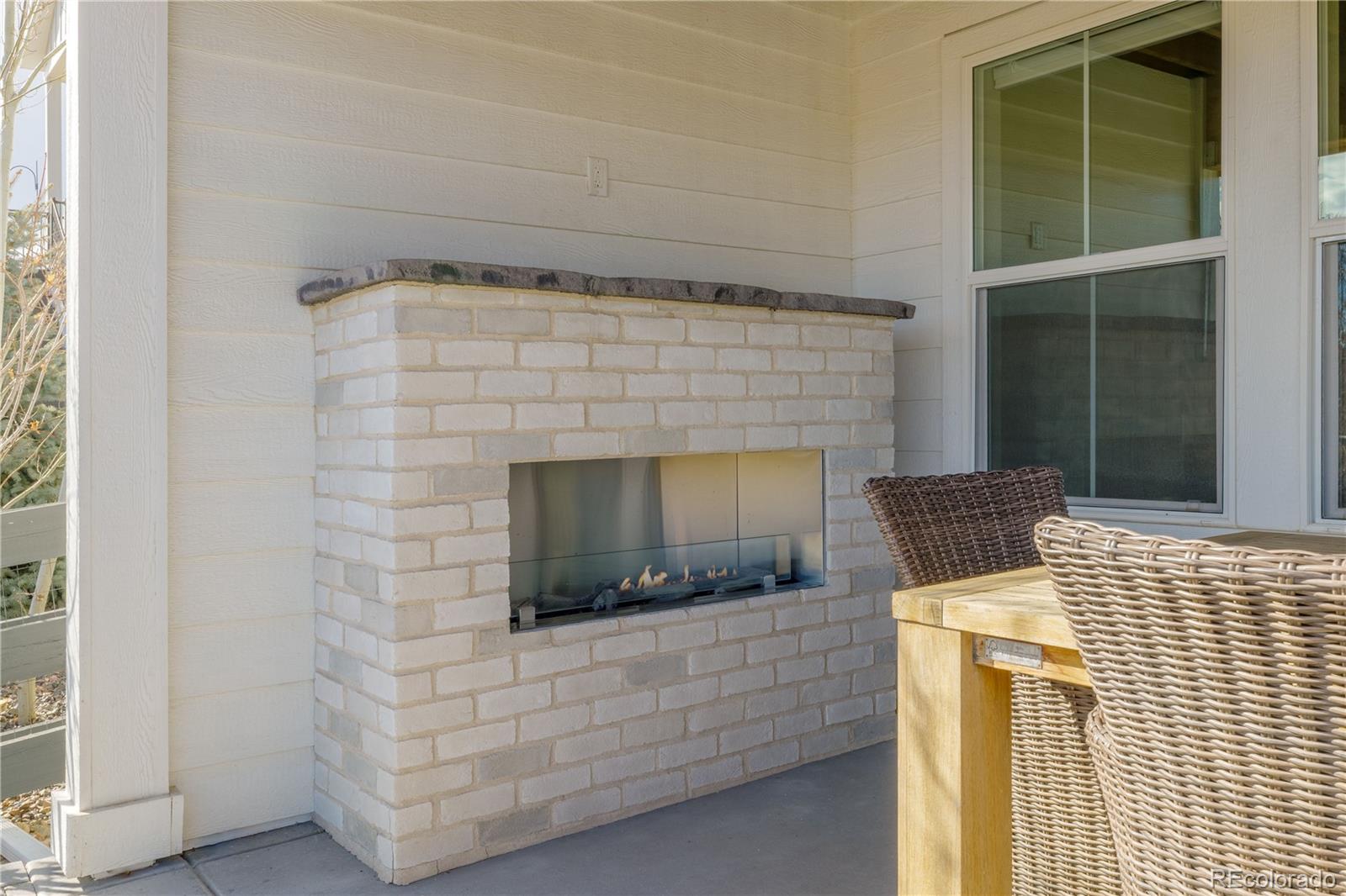 6976 Rim Ridge Drive Castle Pines, CO 80108 - Photo 46 of 50 a living room with a fireplace