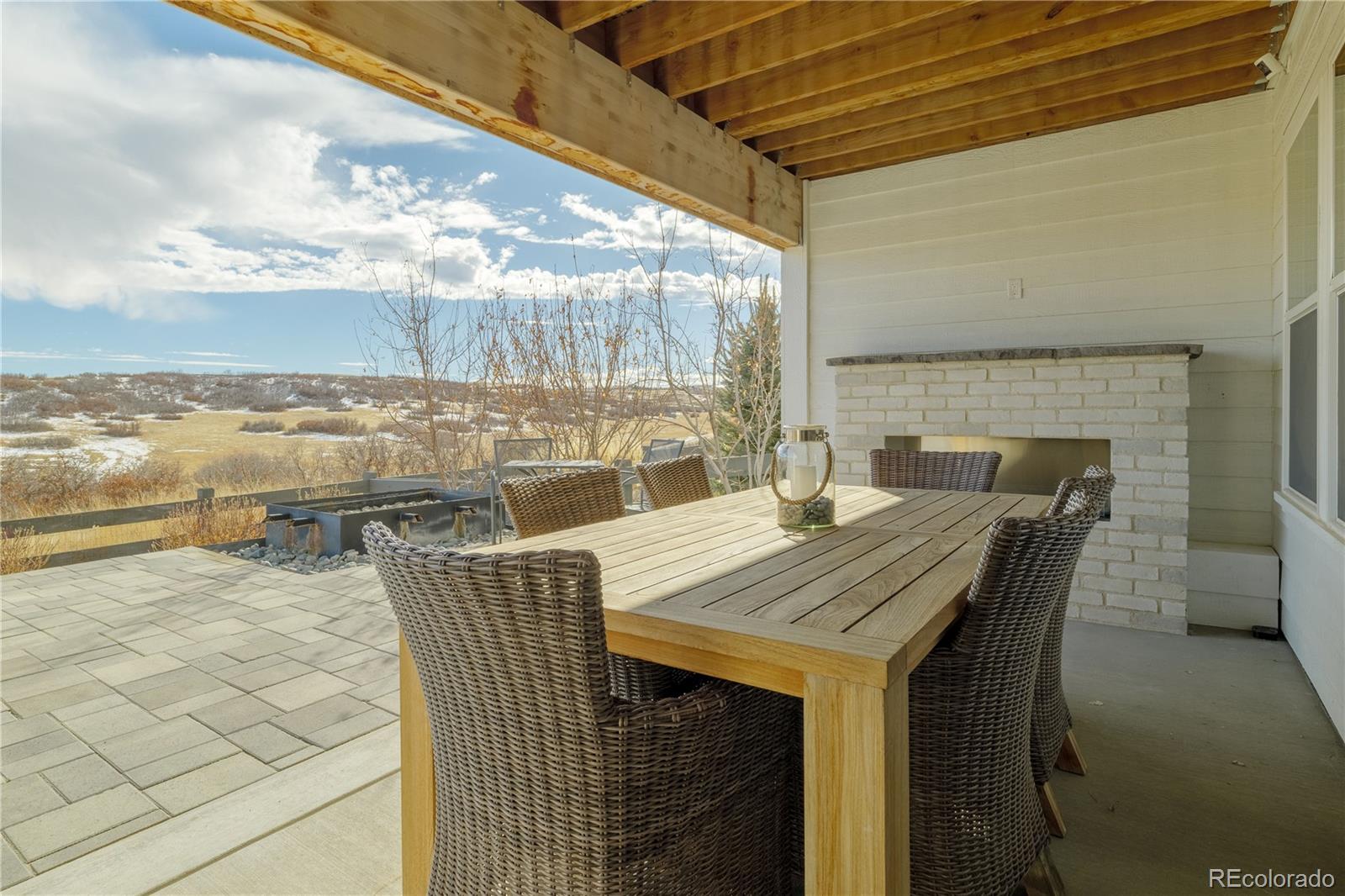 6976 Rim Ridge Drive Castle Pines, CO 80108 - Photo 47 of 50 a terrace with outdoor seating and city view