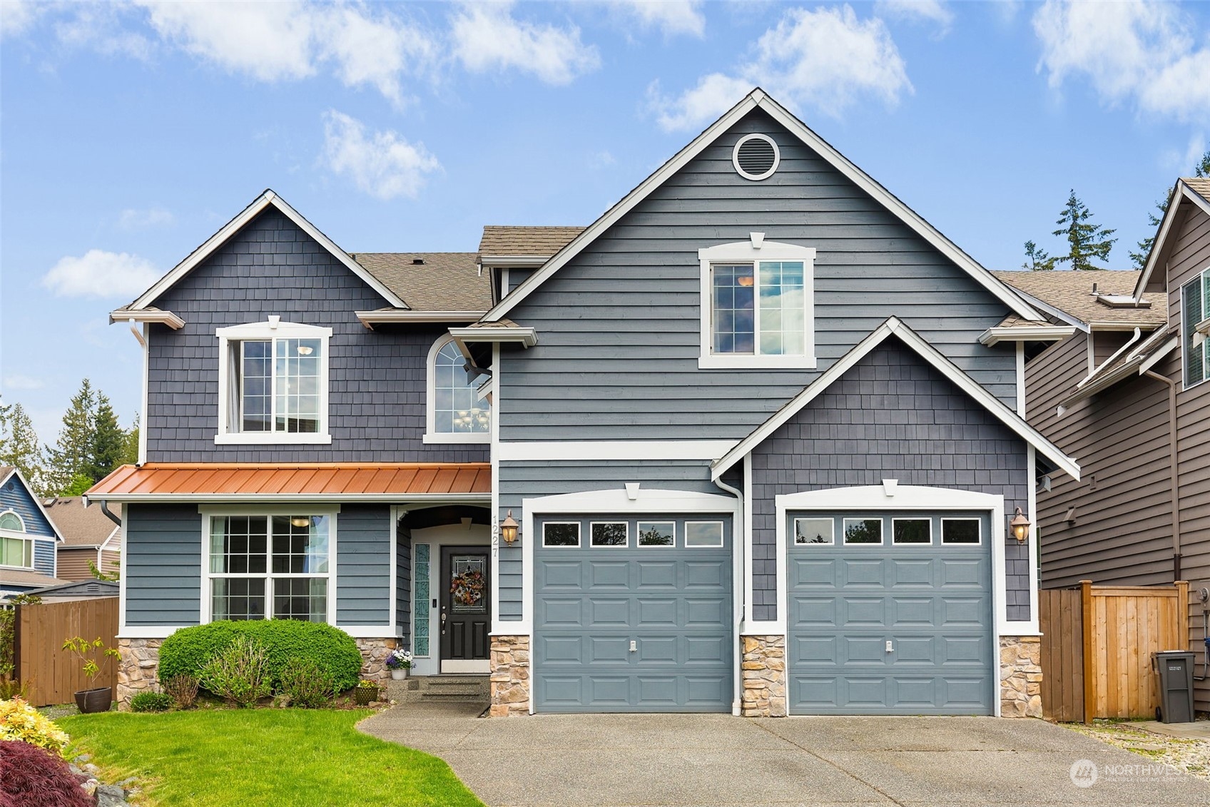1227 187th Street Southeast Bothell, WA 98012 - Photo 1 of 38 a front view of a house with garage