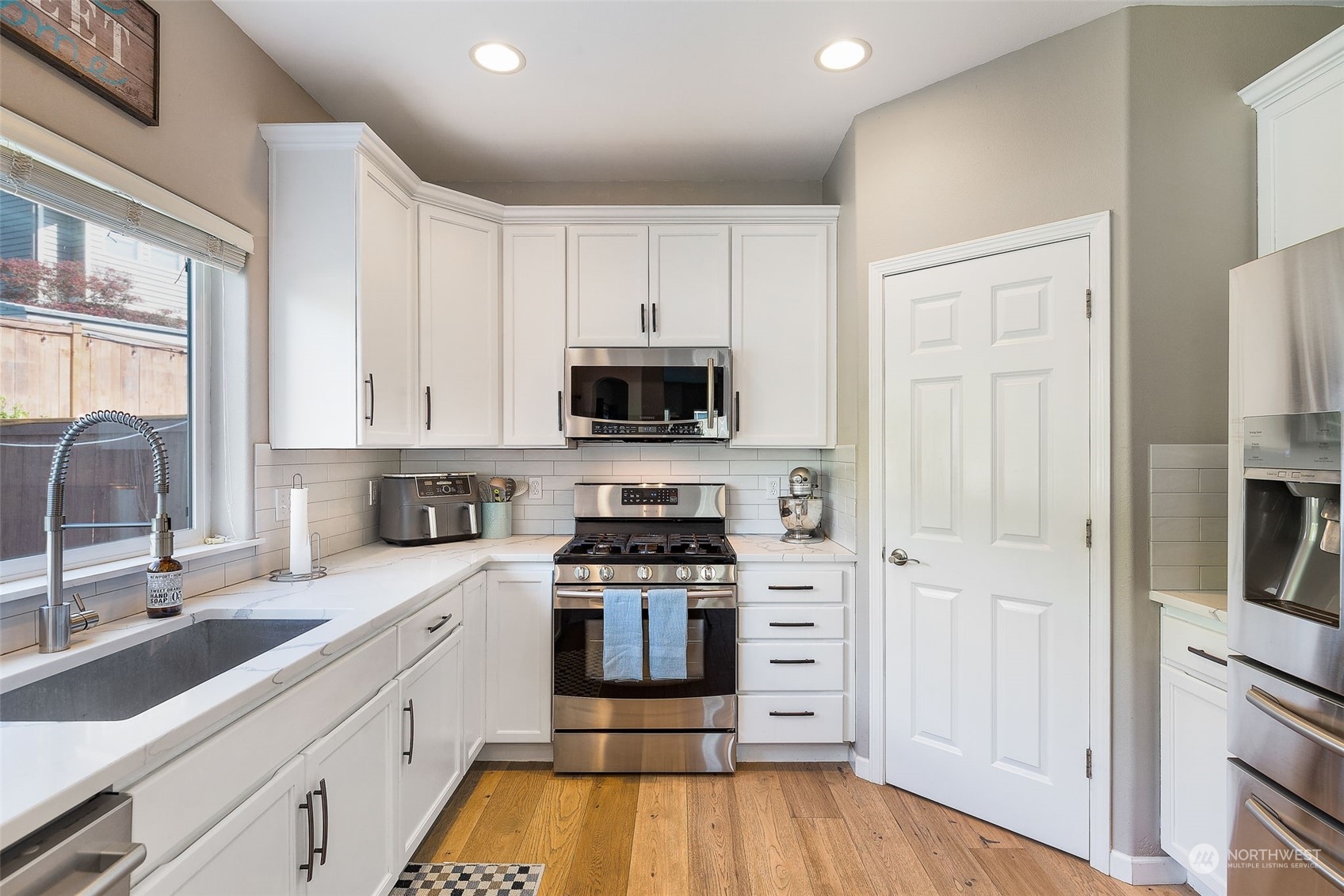1227 187th Street Southeast Bothell, WA 98012 - Photo 13 of 38 a kitchen with white cabinets and appliances