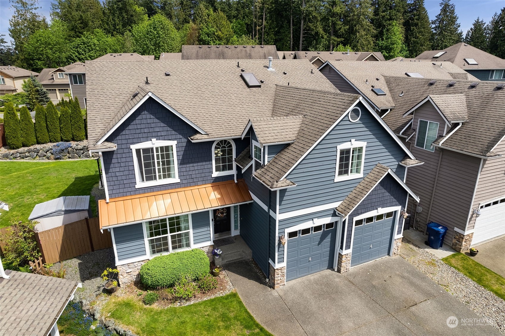 1227 187th Street Southeast Bothell, WA 98012 - Photo 2 of 38 a aerial view of a house with a yard and potted plants