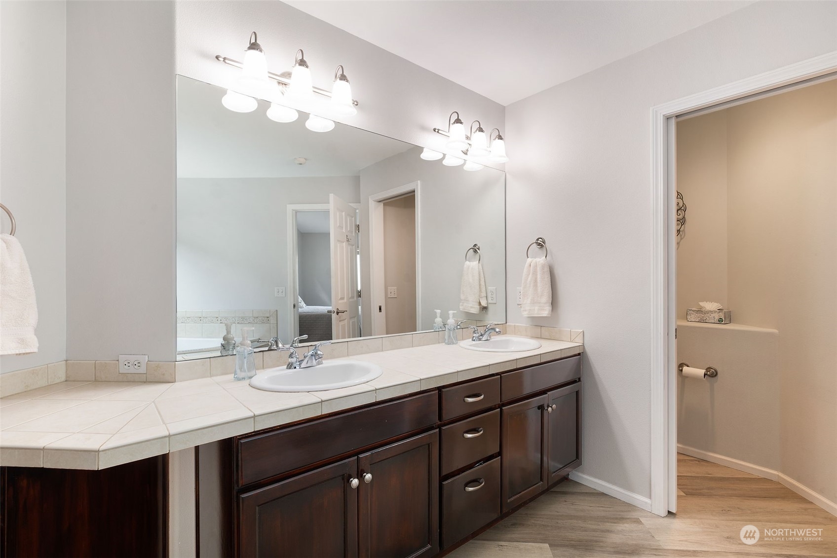 1227 187th Street Southeast Bothell, WA 98012 - Photo 23 of 38 a bathroom with double vanity sinks a vanity a lamp and a mirror