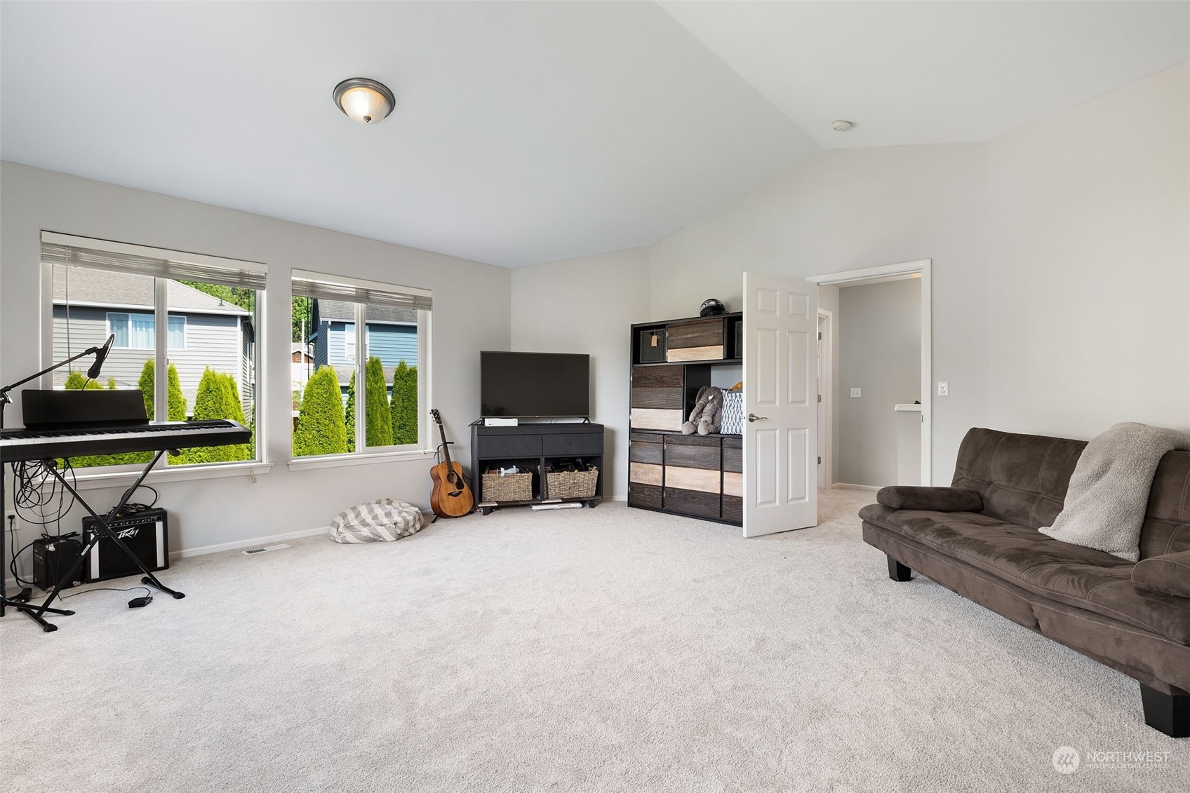 1227 187th Street Southeast Bothell, WA 98012 - Photo 26 of 38 a living room with furniture and a flat screen tv