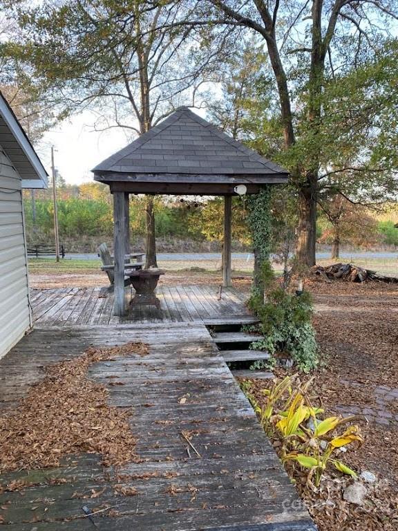 671 Jess Lamb Road Rutherfordton, NC 28139 - Photo 12 of 31 a view of a patio with table and chairs under an umbrella