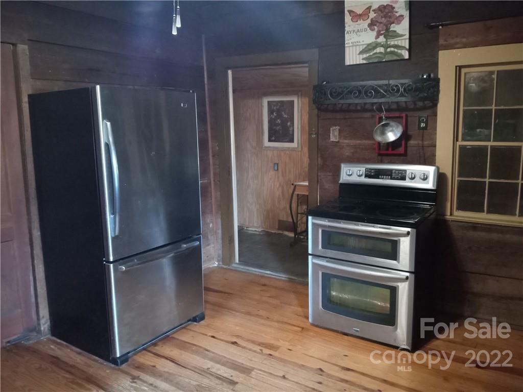 671 Jess Lamb Road Rutherfordton, NC 28139 - Photo 18 of 31 a kitchen with a refrigerator stove and cabinets