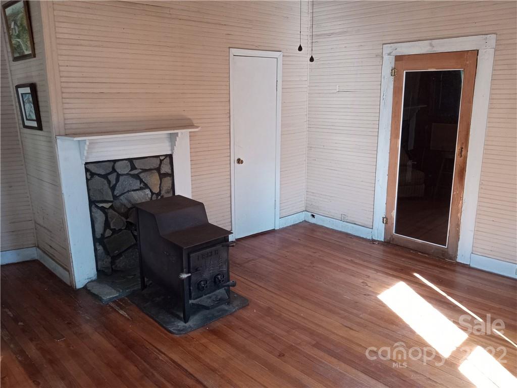 671 Jess Lamb Road Rutherfordton, NC 28139 - Photo 21 of 31 a living room with wooden floors and a fireplace
