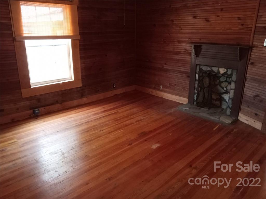 671 Jess Lamb Road Rutherfordton, NC 28139 - Photo 22 of 31 a view of an empty room with wooden floor and a window