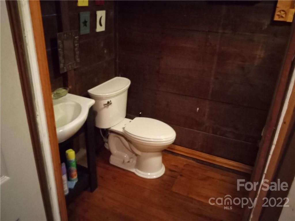 671 Jess Lamb Road Rutherfordton, NC 28139 - Photo 23 of 31 a white toilet sitting next to a sink and a mirror
