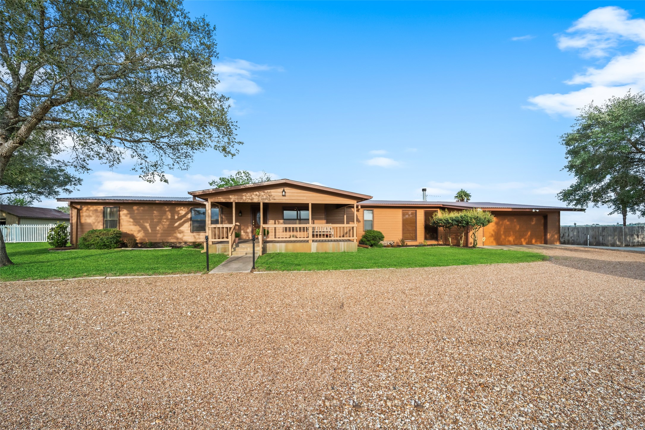 119 Fm 1891 Shiner, TX 77984 - Photo 5 of 40 a front view of a house with a yard and garage