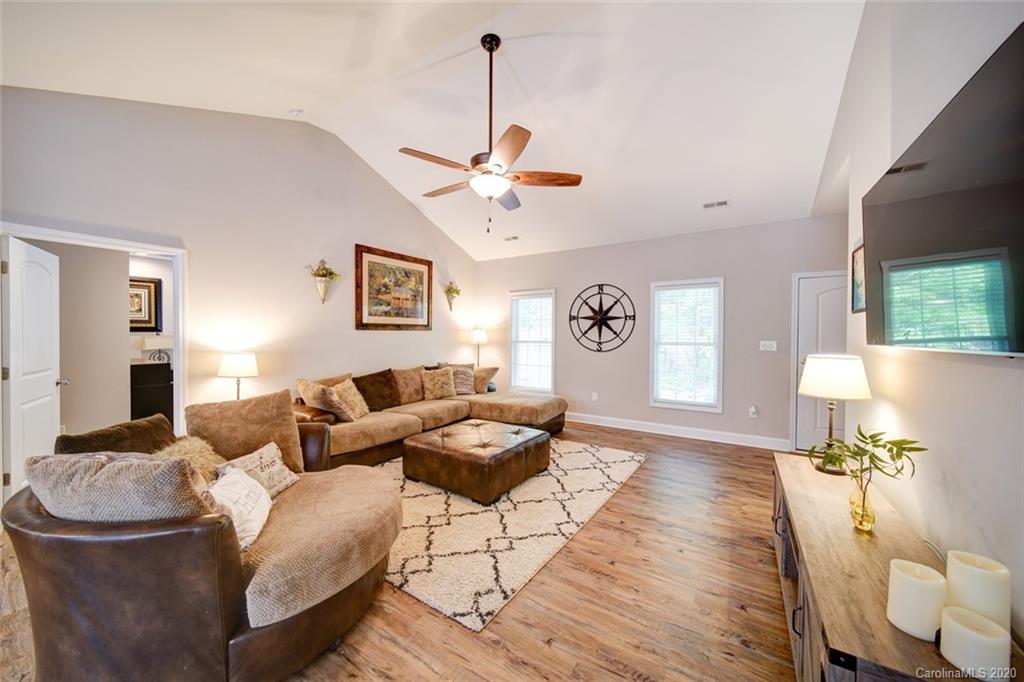3018 Ranger Road Clover, SC 29710 - Photo 15 of 31 a living room with couches a fireplace and a dining table with wooden floor