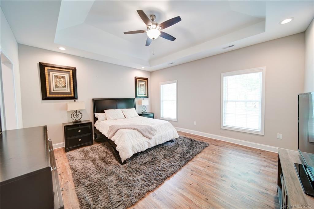 3018 Ranger Road Clover, SC 29710 - Photo 19 of 31 a bedroom with a large bed and a chandelier