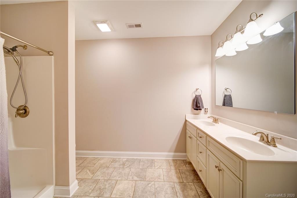 3018 Ranger Road Clover, SC 29710 - Photo 22 of 31 a bathroom with a double vanity sink a mirror and a shower