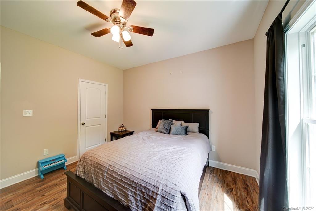 3018 Ranger Road Clover, SC 29710 - Photo 24 of 31 a bedroom with a bed and a chandelier