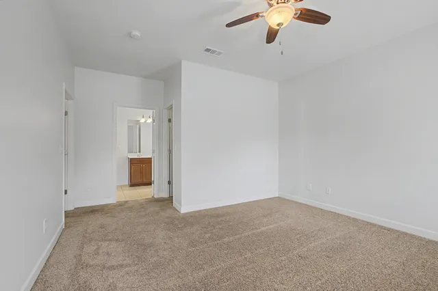 a view of a livingroom with a ceiling fan and window