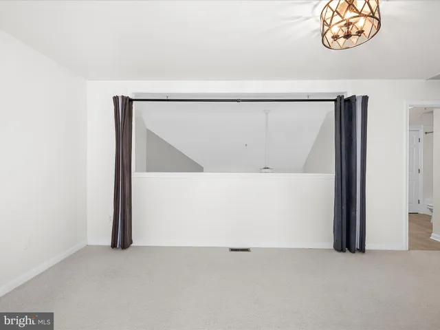 a view of a hallway with an empty room