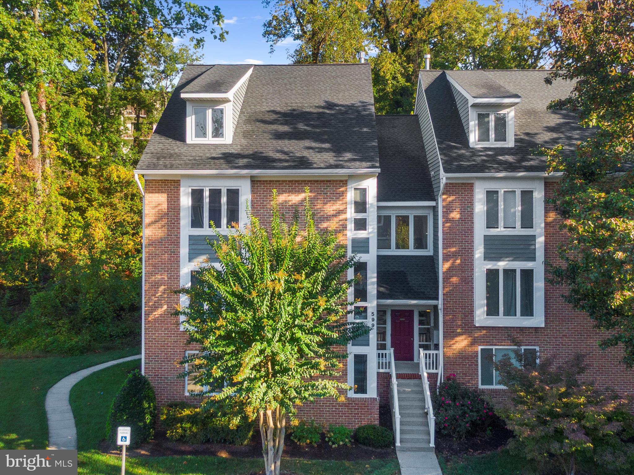 599 Oakland Hills Drive, Unit 3A Arnold, MD 21012 - Photo 2 of 31 front view of house with a yard and potted plants