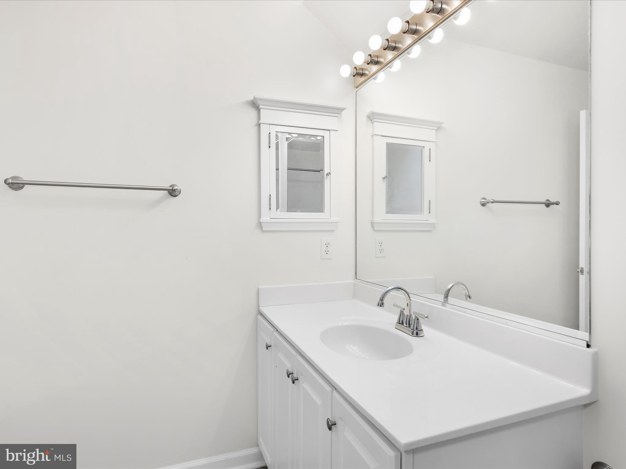 599 Oakland Hills Drive, Unit 3A Arnold, MD 21012 - Photo 22 of 31 a bathroom with a sink and a mirror