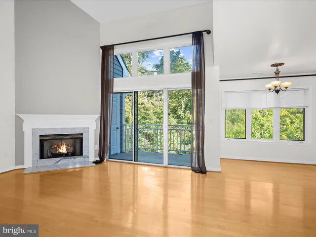 a view of an empty room with a fireplace and a window