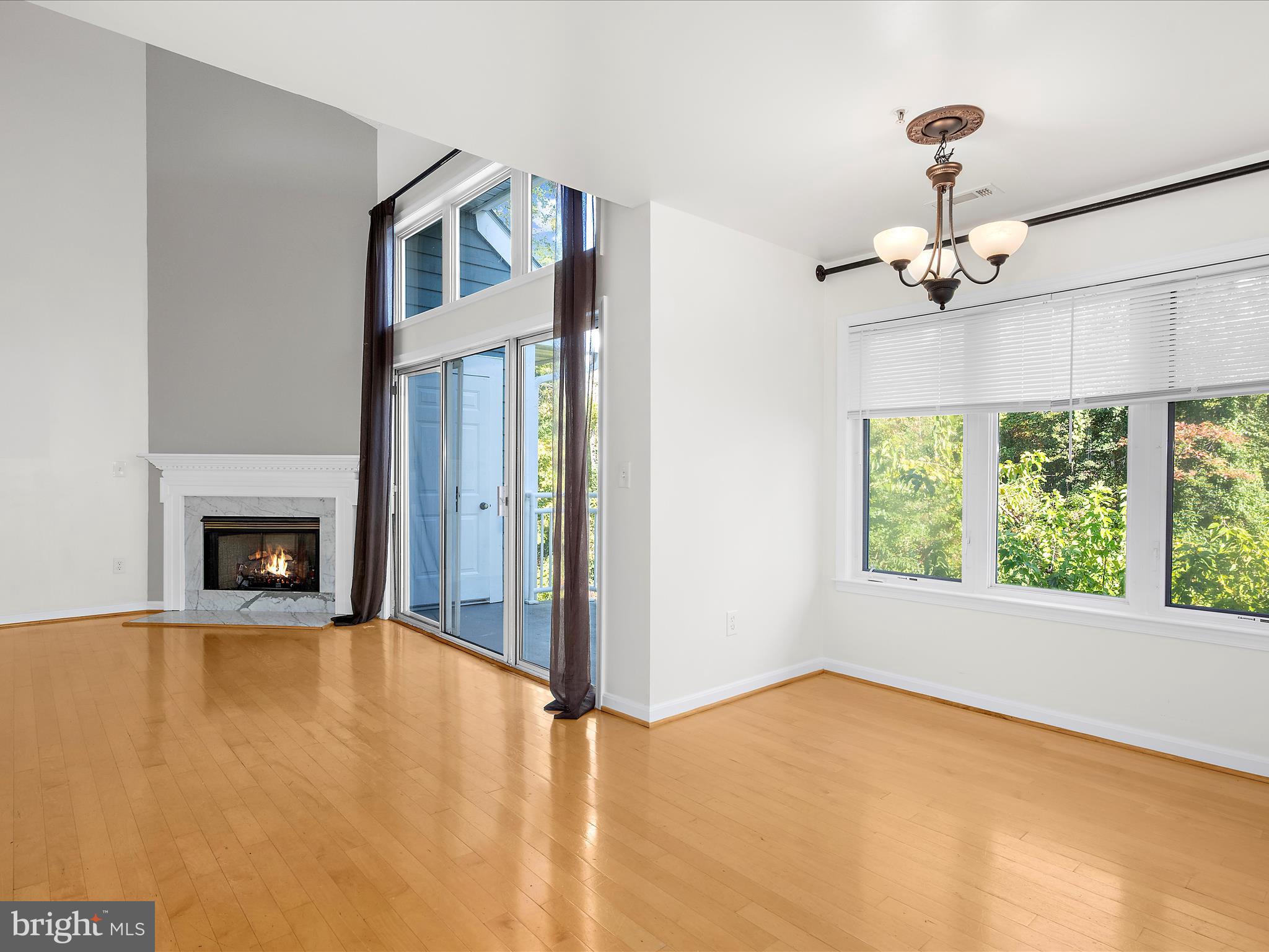 599 Oakland Hills Drive, Unit 3A Arnold, MD 21012 - Photo 5 of 31 a view of an empty room with a fireplace and a window