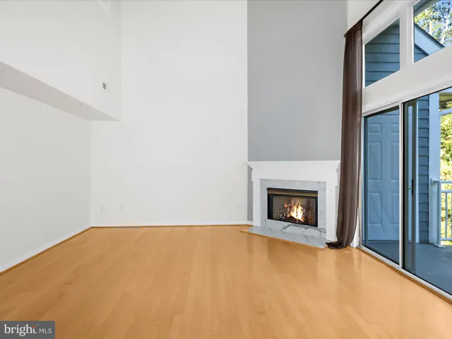 a view of empty room with a fireplace
