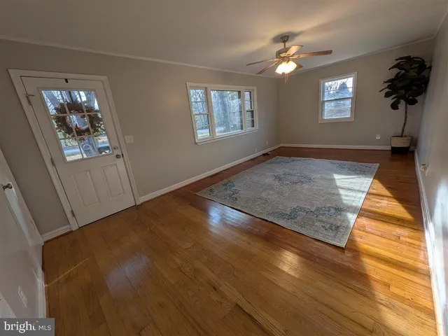 wooden floor in an empty room with a window